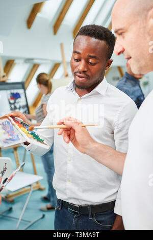 Gli studenti di arte in un creative principiante classe di pittura o di laboratorio di pittura di apprendimento Foto Stock