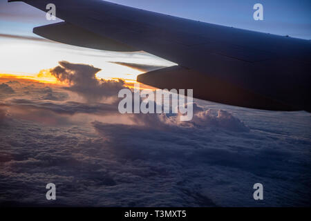 Vista dalla splendida e grande finestra oscurata della Qantas Boeing 787 Dreamliner volare sopra le nuvole si avvicinano Sydney su un volo diretto da LAX Foto Stock
