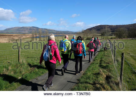 Walkers sul sentiero del Patrimonio attorno a Loch Leven Riserva Naturale, Fife, Scozia Foto Stock