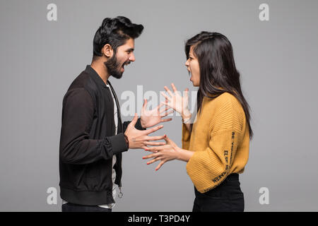 Emotional coppia giovane quarreling isolato su bianco Foto Stock