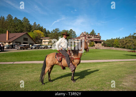 Ranger del Parco sul suo cavallo vicino lo stato Game Lodge (in background), Custer State Park, Black Hills, Dakota del Sud, STATI UNITI D'AMERICA Foto Stock