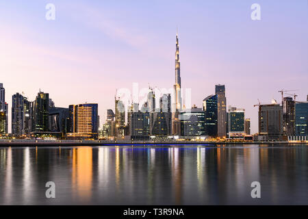 Meravigliosa vista panoramica della skyline di Dubai durante il tramonto con il magnifico Burj Khalifa e molti altri edifici e grattacieli. Foto Stock