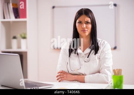 Ritratto di angry medico nel suo ufficio. Foto Stock