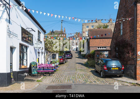 Auto parcheggiate su Kings Arms Hill, una ripida strada di ciottoli in Arundel, West Sussex, in Inghilterra, Regno Unito. Foto Stock