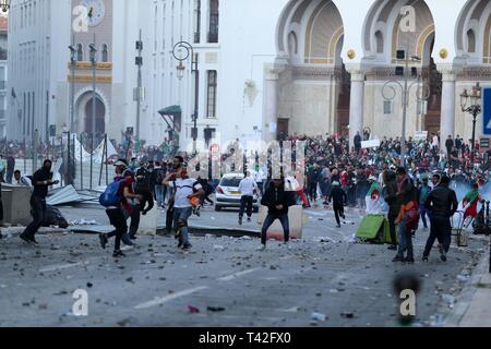 (190413) -- Algeri, 13 aprile 2019 (Xinhua) -- eruttano gli scontri tra manifestanti e anti-sommossa forze durante il mese di marzo a respingere la nomina di Abdelkader Bensalah come presidente ad interim ad Algeri, Algeria, il 12 aprile 2019. Gli algerini il venerdì in scena su larga scala di marche di respingere la nomina di Abdelkader Bensalah come presidente ad interim. Le marche sono state condotte in Algeria, mentre il più grande è stato nella capitale di Algeri dove milioni di persone hanno preso la strada per esigere la partenza dell'attuale presidente ad interim e membri della cura-assunzione cabinet. (Xinhua) Foto Stock