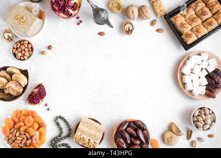 Assortimento, set di Eastern, arabo, turco dolci, frutta a guscio e frutta secca su bianco, vista dall'alto, copia dello spazio. Holiday Medio Orientale dolce tradizionale foo Foto Stock