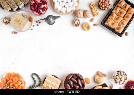 Assortimento, set di Eastern, arabo, turco dolci, frutta a guscio e frutta secca su bianco, vista dall'alto, copia dello spazio. Holiday Medio Orientale dolce tradizionale foo Foto Stock