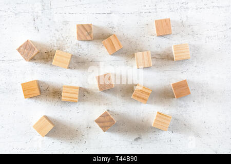 Vuoto cubi di legno sparsi sulla pietra bianca bordo, piatto foto laici Foto Stock