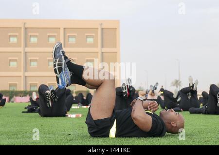 Stati Uniti Il personale dell'esercito Sgt. Brian capelli, 335a comando di segnalazione (Teatro) (provvisorio), conduce la forma fisica della formazione di Camp Arifjan, Kuwait, 22 febbraio, 2019. L'evento di formazione featured pochi esercizi di ritorno dal passato. Foto Stock