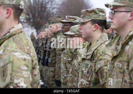 SKWIERZYNA, Polonia (feb. 23, 2019) - Un plotone di soldati dal 101st brigata battaglione di supporto, 1° Brigata corazzate contro la squadra, 1a divisione di fanteria, assistere ad una cerimonia a sostegno di 61 polacco cadetti prestando giuramento di difendere e di servire il proprio paese, nel centro della città. Foto Stock