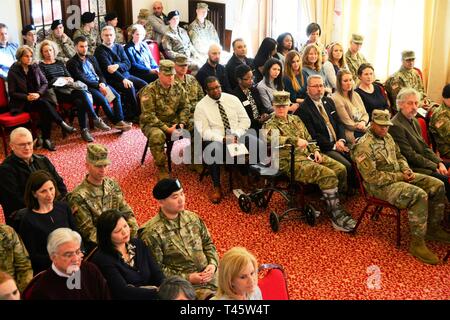 I soldati e i membri della famiglia si riuniscono per la modifica del comando di U.S. Army Health Clinic presso il Von Steuben centro comunitario in Ansbach, Germania, 8 marzo 2019. Durante la cerimonia, Col. Burke Bristow (comandante uscente), lasciò il comando di Lt. Col. Daniel contanti (comandante in arrivo). La modifica del comando cerimonia è un evento Costruire sulla tradizione, simbologia, e patrimonio. La chiave per la cerimonia è il passaggio dei colori, che è un simbolo di autorità, che rappresentano le sue responsabilità per l'organizzazione. Il passaggio dei colori simboleggia il trasferimento di autorità dal outgoi Foto Stock