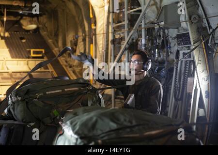 Stati Uniti Marine Corps Cpl. Shane Roberto protegge il carico su una KC-130J Super Hercules in Subic Bay, Filippine prima di una caduta di aria da una KC-130J Super Hercules oltre il colonnello Ernesto Ravina Air Base, Filippine, 8 aprile 2019, durante l'esercizio Balikatan. Balikatan è un esercizio annuale tra gli Stati Uniti e le Filippine e proviene da una frase Tagalog significato houlder "a spalla", che rappresenta la relazione tra i due paesi. L'esercizio promuove la sicurezza regionale e gli sforzi umanitari per Stati Uniti alleati e partner. Roberto, un Yona, Guam, nativo è un crewmaster con antenna Marine ri Foto Stock