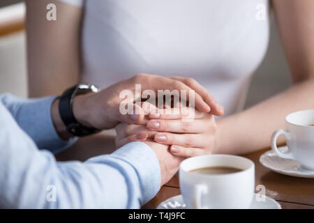 Close up di maschio e femmina azienda ogni altre mani Foto Stock
