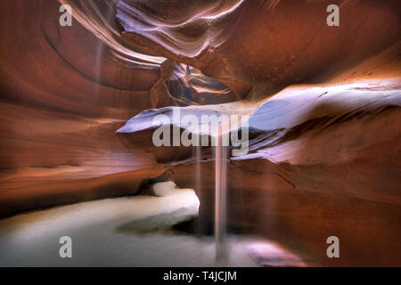 Queste slot canyon sono formate da erosione producendo una forma che scorre alle pareti di pietra arenaria. La luce del sole producendo una bella illuminazione etereo effetto. Foto Stock