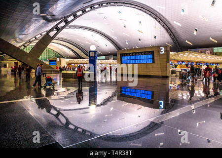 Doha, Qatar - 24 Febbraio 2019: Qatar Airways check-in i passeggeri nel nuovo e moderno Hamad International Airport o Doha Aeroporto Hamad, riflessa Foto Stock