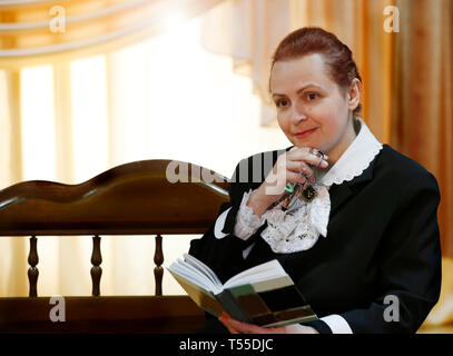 Una donna anziana con un libro. Il primo maestro. Poetessa e scrittrice Foto Stock