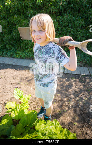 Dieci anni di ragazza con un giardino vanga su un riparto REGNO UNITO Foto Stock