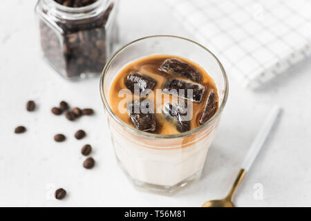 Ice caffè con latte su sfondo di calcestruzzo. Freddo gustosa bevanda rinfrescante Foto Stock