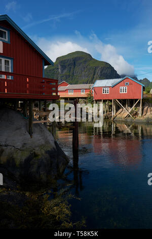 Il rorbu rosso tradizionale norvegese case di pescatori costruito su palafitte di legno nel villaggio di pescatori di Å su Moskenesøya nelle isole Lofoten in Norvegia Foto Stock