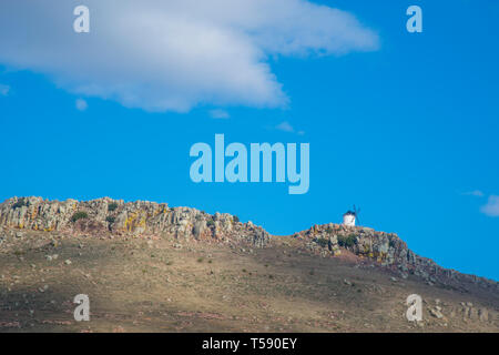 Mulino a vento sulla cima di una collina. Fuente El Fresno, Ciudad Real Provincia, Castilla La Mancha, in Spagna. Foto Stock