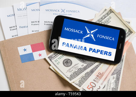 Cracovia in Polonia - Aprile 6, 2016 : Cartella con Mossack Fonseca logo e i documenti stampati dal suo sito web, Panama bandiera, USA e UE valuta e telefono. Foto Stock