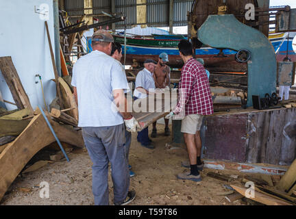 I lavoratori del cantiere navale in cui i tradizionali fiume Tago barche sono costruiti e riparati in Sarilhos Pequenos village a Moita comune, Portogallo Foto Stock