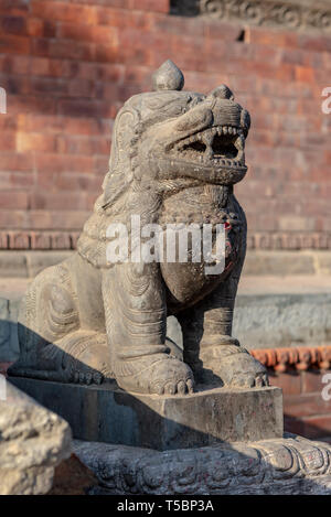 Lion protezione nella parte anteriore di uno dei templi di Pashupatinath, presa su un soleggiato lato molla del pomeriggio, Nepal Foto Stock