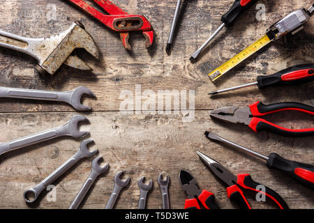 La creazione di strumenti di riparazione su sfondo di legno. Vista dall'alto. Copyspace Foto Stock