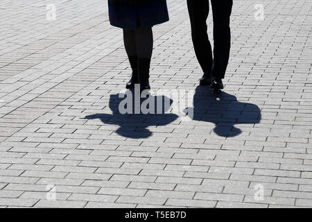 I contorni e le ombre di due persone a piedi giù per la strada. Amore giovane all'aperto, il concetto di relazione, amicizia vita drammatica Foto Stock