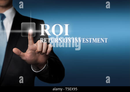 Il concetto di business - imprenditore nel soddisfare preme virtuale pulsante tattile - ROI il ritorno sugli investimenti Foto Stock