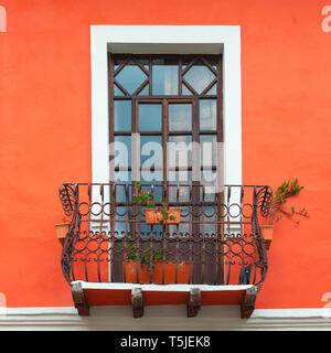 In stile coloniale e balcone con finestra e coralli viventi tonalità arancione facciata a parete nel centro storico della città di Cuenca, Ecuador. Foto Stock