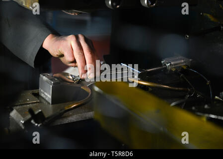 Guy Degrenne nella factory di Vire (Normandia, a nord-ovest della Francia), specializzata nella posateria e argenteria. Acciaio inossidabile argenteria workshop: lavoratore usi Foto Stock