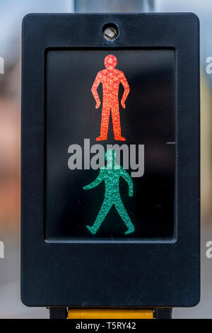 Il design classico del passaggio pedonale che mostra sia il rosso e il verde uomo illuminato. Foto Stock