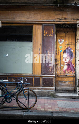 Il design di tag di una bella donna sulla porta di un negozio di Bordeaux Foto Stock