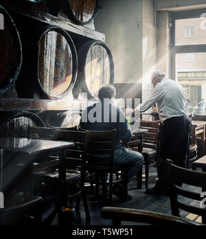 Madrid, Spagna - 11 aprile 2019. Un cameriere che serve a un cliente al tavolo in una taverna spagnola di Madrid centro. Spagna. Foto Stock