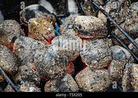 Hot barbecue brace viene incendiata in primo piano sullo sfondo Foto Stock