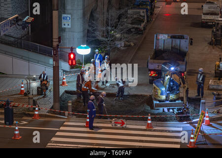 Odaiba, Giappone - 9 Aprile 2019 - costruzione stradale lavoratori fissare il marciapiede di notte in Odaiba, Giappone la notte del 9 aprile 2019 Foto Stock