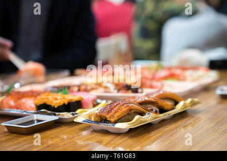 Anguilla sushi, e altri sushi; salmone, otoro, trasandato, Grigliata di gamberi, granchi sono disposti sul tavolo pronti a mangiare. Foto Stock