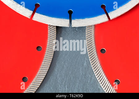 Diamante rosso ruote per granito e pietra, blu per calcestruzzo di cemento armato, su una lastra di grigio pietra arenaria Foto Stock