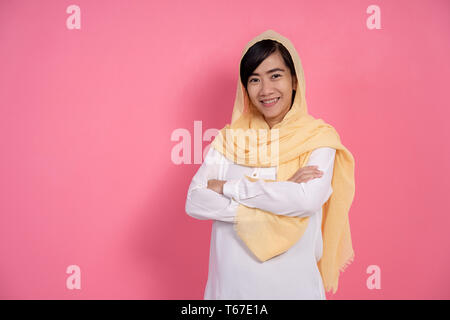 Donna musulmana del braccio incrociato sorridente Foto Stock