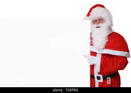Nikolaus Weihnachtsmann mit Mütze zeigt un Weihnachten auf leeres Schild mit Textfreiraum Foto Stock