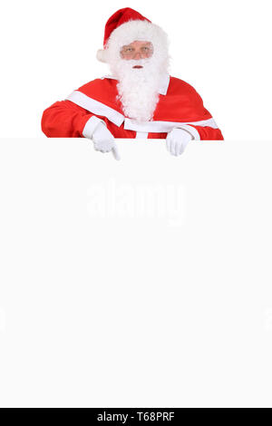 Nikolaus Weihnachtsmann zeigt un Weihnachten auf leeres Schild Foto Stock