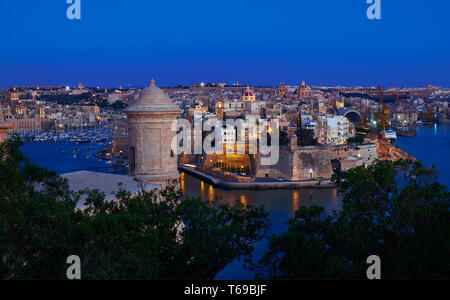 La vista notturna del Grand Harbour, Senglea penisola e torre di guardia sul primo piano di La Valletta Foto Stock