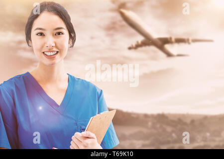 Immagine composita di infermiera asiatica con uno stetoscopio guardando la telecamera contro uno schermo bianco Foto Stock
