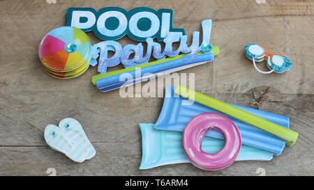Party in piscina il testo con gli occhiali zattera flip flop palla spiaggia su uno sfondo di legno Foto Stock