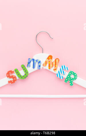 Creative vista superiore piatto bianco laici i portabiti in legno estate testo rosa pastello sfondo spazio copia stile minimalista. Il modello femminile di moda blog sociale Foto Stock