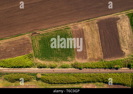 Vista aerea della ferrovia attraverso il paesaggio di campagna, dall'alto verso il basso la prospettiva da fuco pov Foto Stock