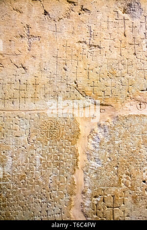 Antica croci scolpite dai pellegrini contrassegnando la posizione di Gesù' sepoltura nelle grotte sotto la chiesa del Santo Sepolcro. Foto Stock