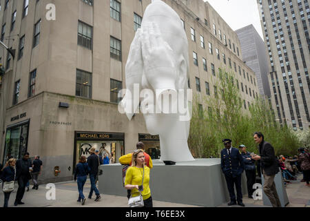 Gli ospiti passano â€oeBehind il Wallsâ€ 2019 dall'artista Juame da Plensa a in corrispondenza della testa del canale di giardini in Rockefeller Center di New York il giorno di apertura del fregio scultura installazione su Giovedì, 25 aprile 2019. Opere di 14 artisti dot il Rockefeller Center il paesaggio come il centro ospita una galleria di artisti dal fregio New York art fair, sul display fino al 28 giugno. (Â© Richard B. Levine) Foto Stock