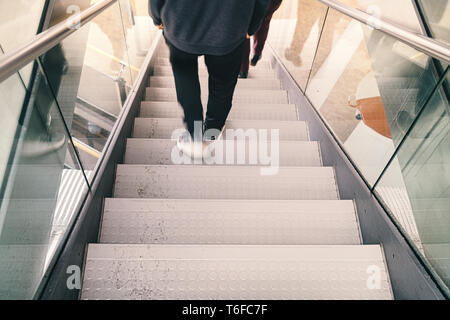 Sfocato gambe di una persona va giù per una scalinata Foto Stock